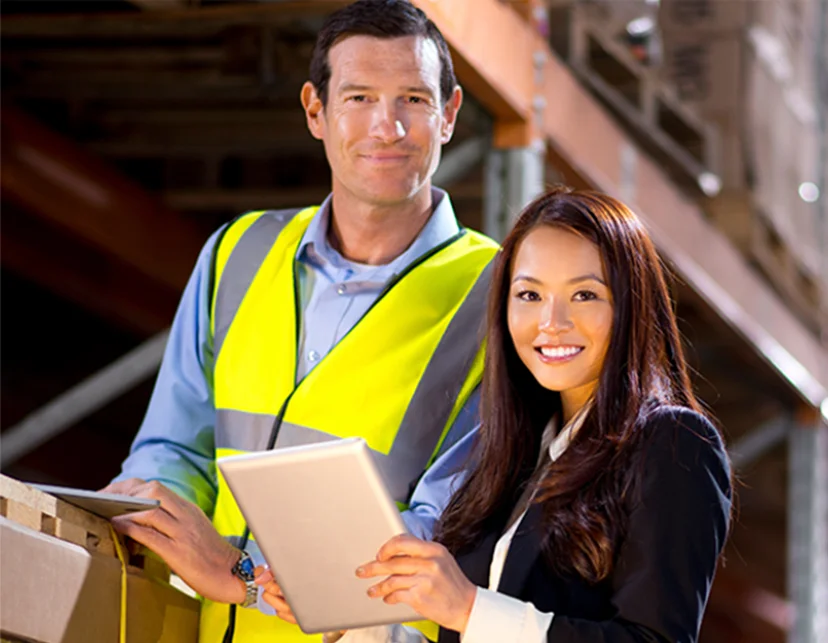 Business owners discussing risk management in warehouse
